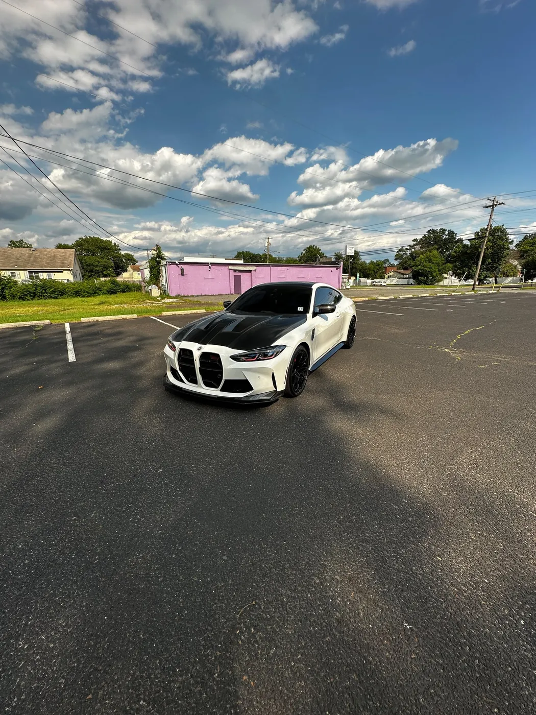 White BMW M4 with carbon hood after a detail