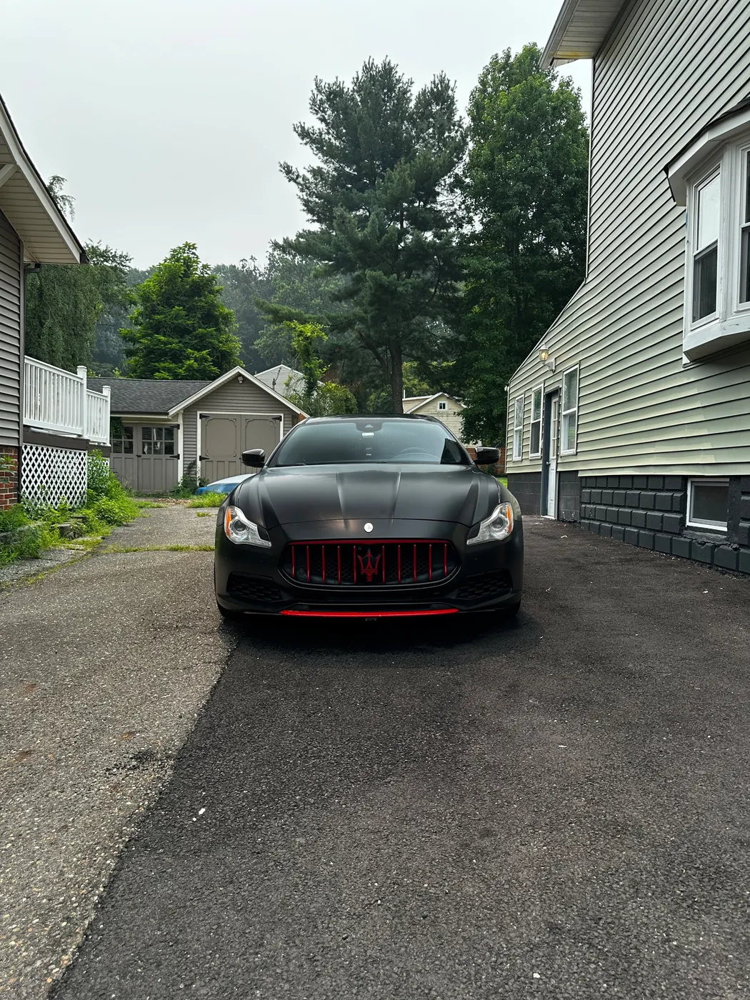 Matte black Maserati detailed in the owner's driveway