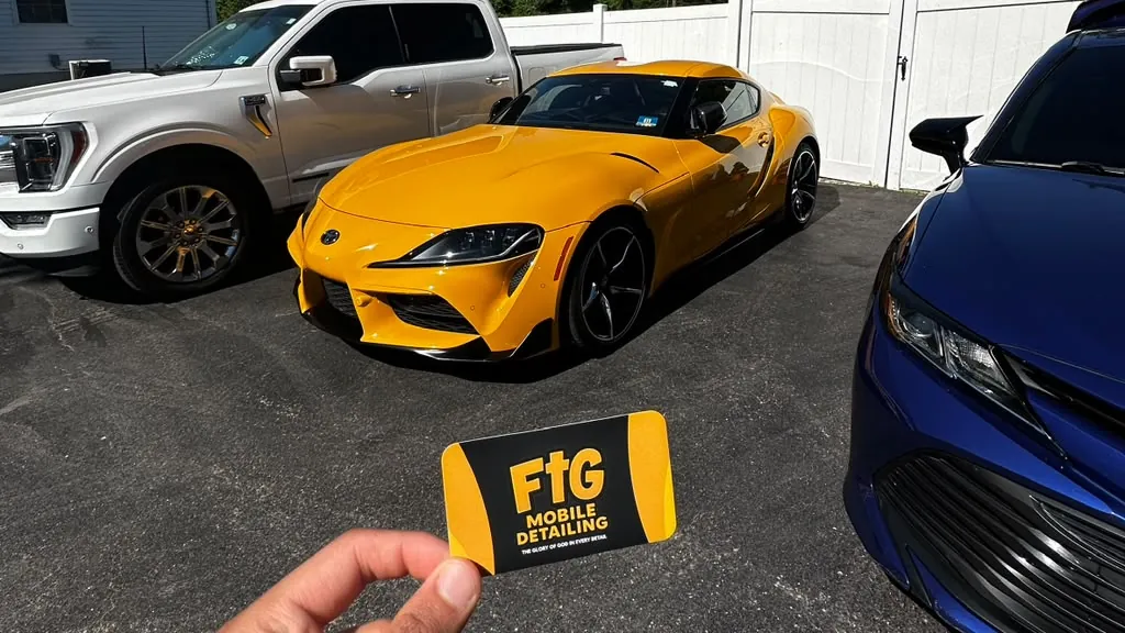 Yellow Toyota Supra detailed by FTG, with the FTG business card